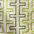 Textile pattern with green and dark green geometric design on a beige background