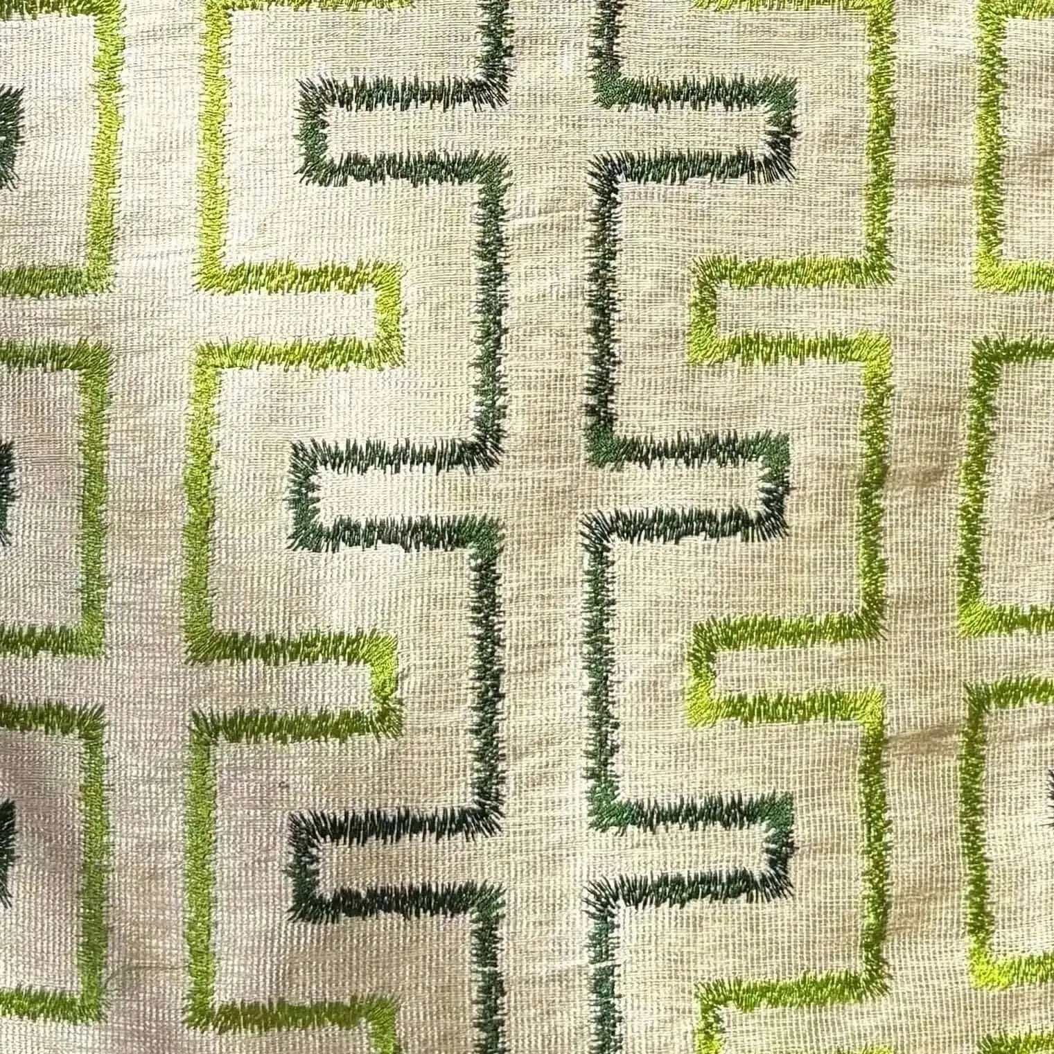 Textile pattern with green and dark green geometric design on a beige background