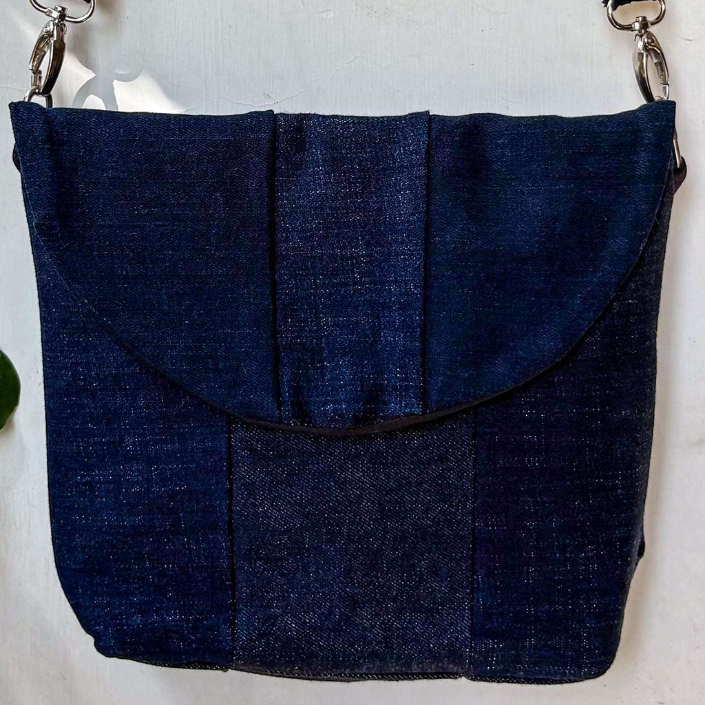 Blue denim handbag on a light gray background