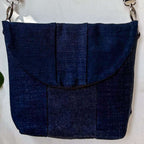 Blue denim handbag on a light gray background