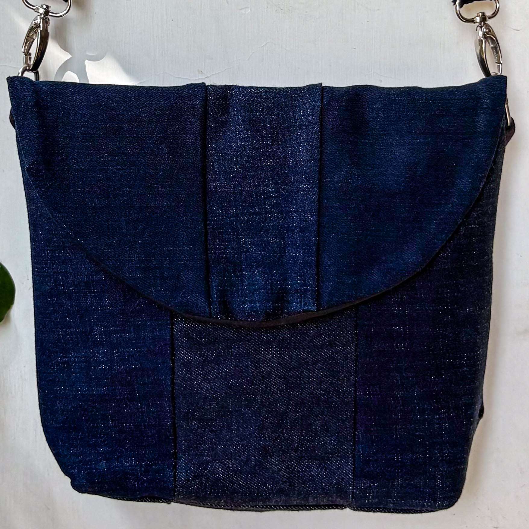 Blue denim handbag on a light gray background