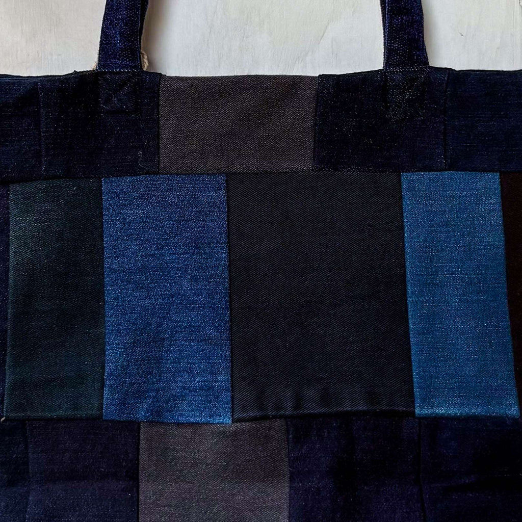 Black and blue checkered tote bag on a white background