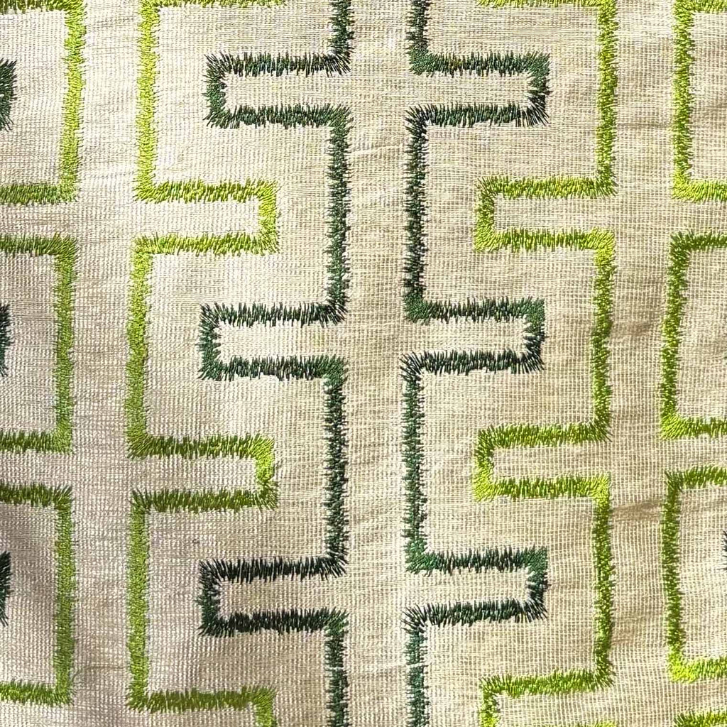 Textile pattern with green and dark green geometric design on a beige background