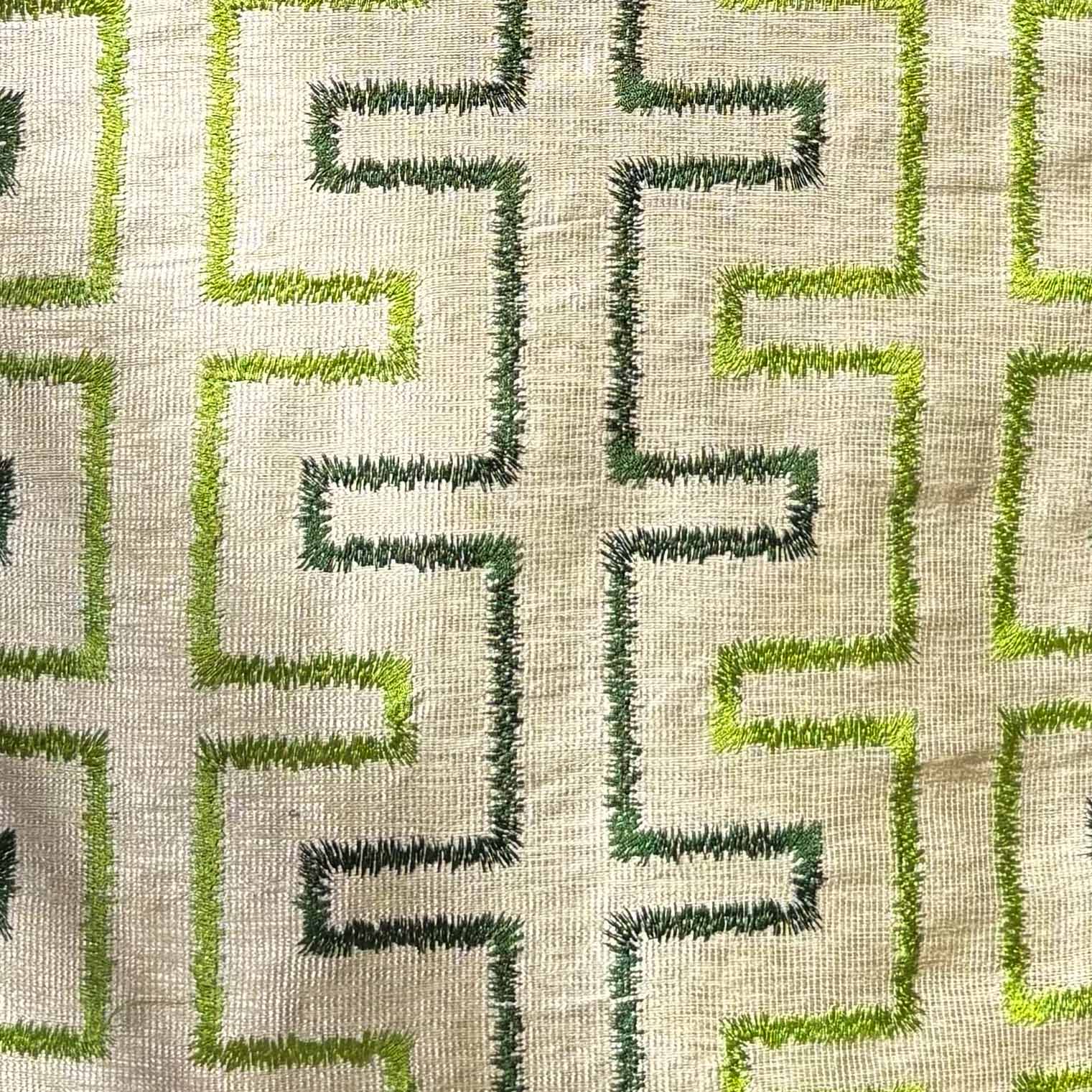 Textile pattern with green and dark green geometric design on a beige background