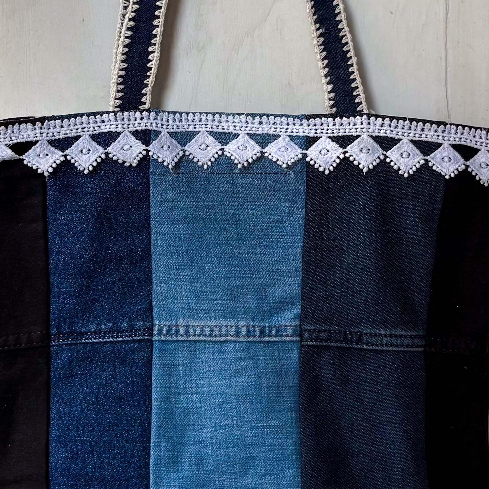 Denim dress with lace trim on a wooden surface