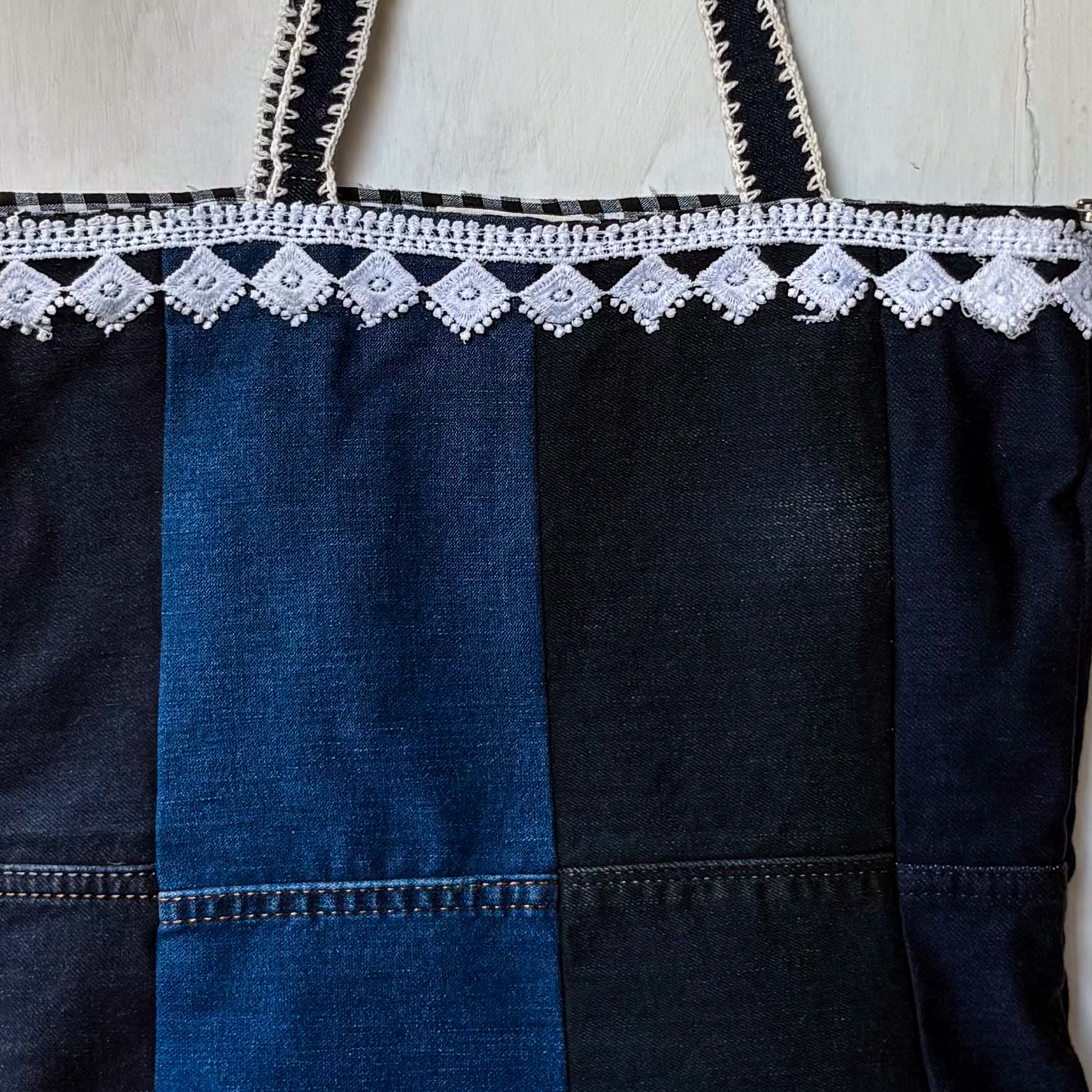 Denim dress with lace trim on a white background